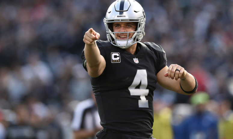 A closeup of Las Vegas Raiders QB Derek Carr pointing with one finger during a game against the Kansas City Chiefs.