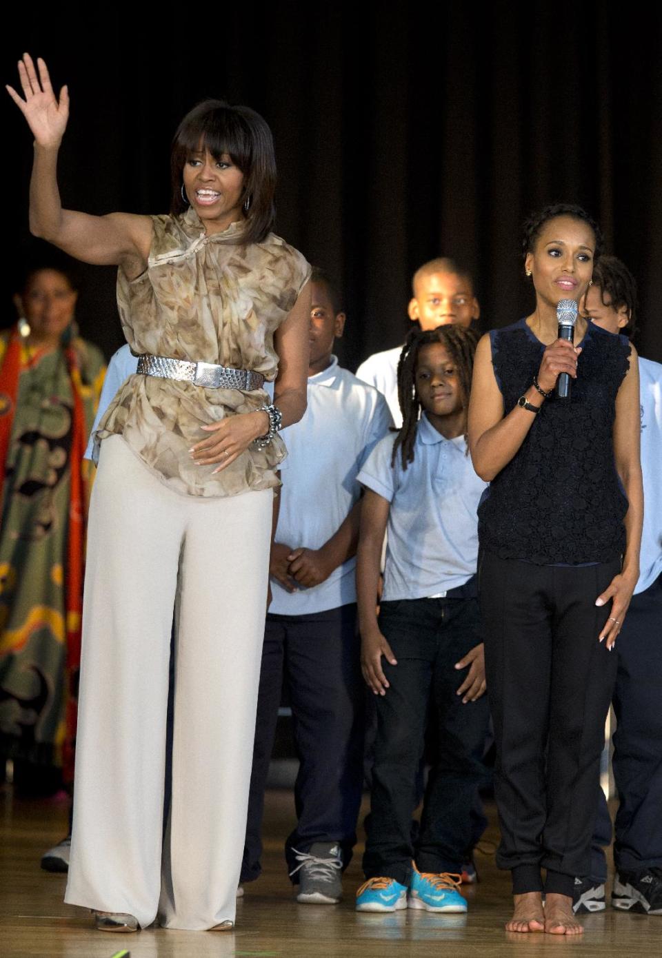 First lady Michelle Obama, left, and actress Kerry Washington say goodbye after a visit to Savoy Elementary School in Washington, Friday, May 24, 2013. The Savoy School was one of eight schools selected last year for the Turnaround Arts Initiative at the President's Committee on the Arts and Humanities. Turnaround Arts Schools use the arts as a central part of their reform strategy to improve low performing schools (AP Photo/Evan Vucci)