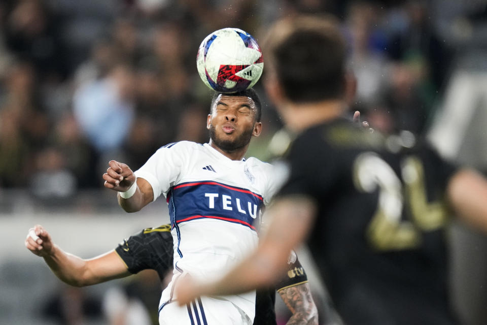 Vancouver Whitecaps midfielder Pedro Vite (45) head the ball during the second half of an MLS soccer match against Los Angeles FC in Los Angeles, Saturday, June 24, 2023. (AP Photo/Ashley Landis)