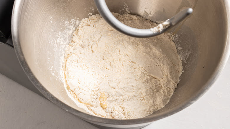 Flour and liquid in a bowl of a stand mixer