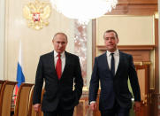 Russian President Vladimir Putin, left, and Russian Prime Minister Dmitry Medvedev walk prior to a cabinet meeting in Moscow, Russia, Wednesday, Jan. 15, 2020. The Tass news agency reports Wednesday that Russian Prime Minister Dmitry Medvedev submitted his resignation to President Vladimir Putin. Russian news agencies said Putin thanked Medvedev for his service but noted that the prime minister's Cabinet failed to fulfil all the objectives set for it. (Dmitry Astakhov, Sputnik, Government Pool Photo via AP)