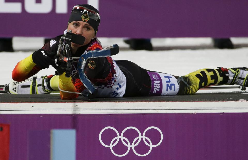 Germany's Andrea Henkel prepares to shoot during the women's biathlon 7.5k sprint, at the 2014 Winter Olympics, Sunday, Feb. 9, 2014, in Krasnaya Polyana, Russia. (AP Photo/Gero Breloer)