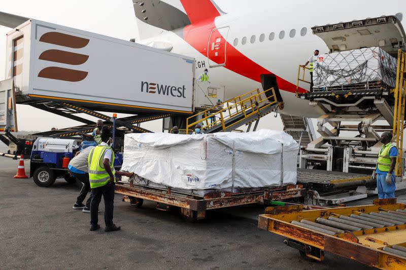Workers offload boxes of AstraZeneca/Oxford vaccines as the country receives its first batch of coronavirus disease (COVID-19) vaccines under COVAX scheme, in Accra