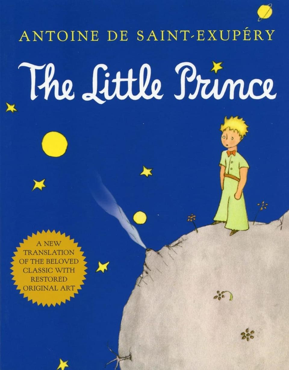 Cover of "The Little Prince" featuring the Prince standing on a planet with stars and a comet above