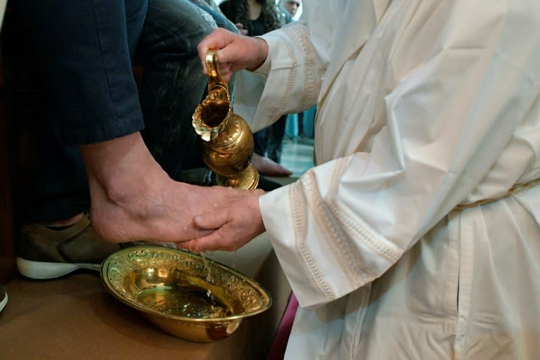 This handout picture released by the Vatican press office shows Pope Francis washing the feet of inmates at the Paliano prison outside Rome on April 13, 2017 during the Holy Thursday celebrations