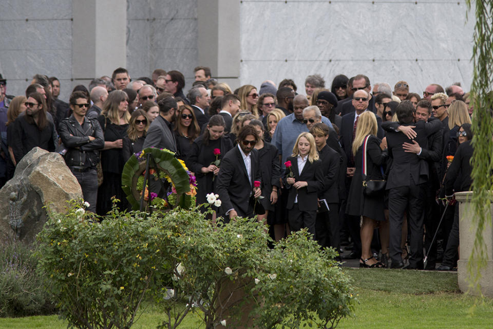 Brad Pitt hugging another mourner during Chris Cornell's memorial service at Hollywood Forever Cemetery on May 26. (Photo: David McNew/Getty Images)