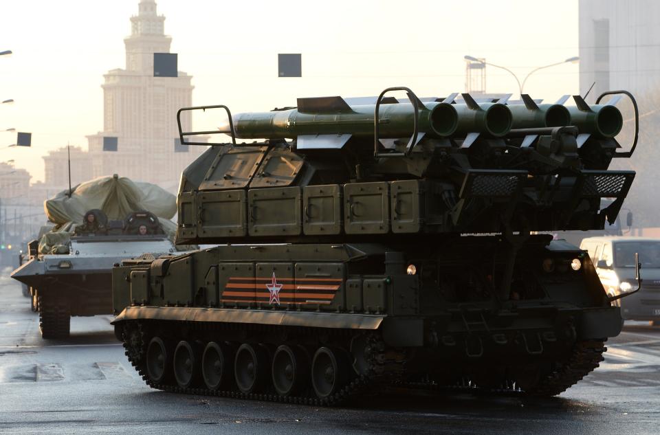 A BUK air defence missile system (R) moves on April 29, 2015 in Moscow for the Victory Day military parade night training.