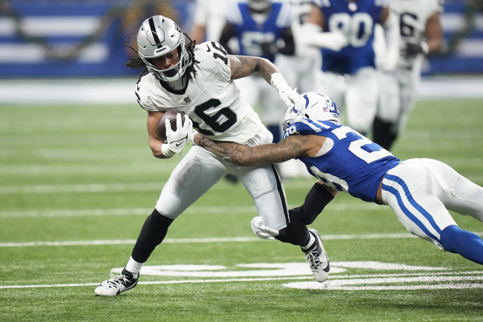 Las Vegas Raiders wide receiver Jakobi Meyers (16) is tackled by Indianapolis Colts cornerback JuJu Brents (29) during the first half of an NFL football game Sunday, Dec. 31, 2023, in Indianapolis. (AP Photo/AJ Mast)