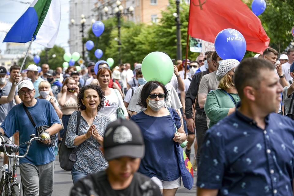 People march during an unsanctioned protest in support of Sergei Furgal, the governor of the Khabarovsk region, who was interrogated and ordered held in jail for two months, in Khabarovsk, 6100 kilometers (3800 miles) east of Moscow, Russia, Saturday, July 25, 2020. Some thousands marched across Khabarovsk to protest the arrest of the region's governor on murder charges, continuing a wave of protests that has lasted for two weeks. (AP Photo/Igor Volkov)