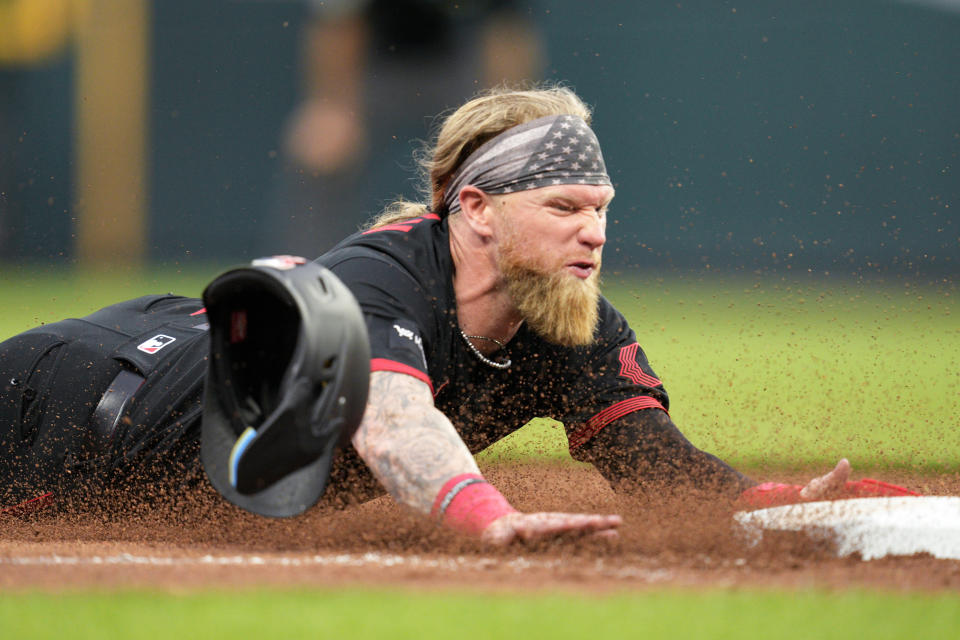 Cincinnati Reds' Jake Fraley steals third base against the New York Yankees during the sixth inning of a baseball game in Cincinnati, Friday, May 19, 2023. (AP Photo/Jeff Dean)