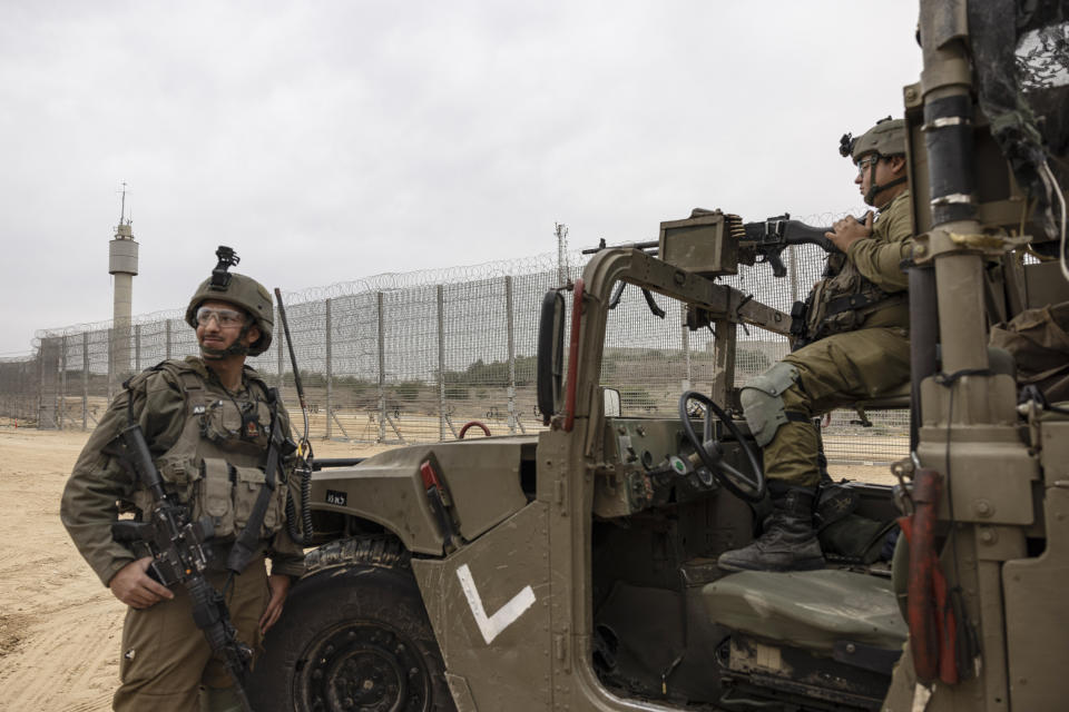 Israeli soldiers secure the ceremony marking the completion of an enhanced security barrier along the Israel-Gaza border, Tuesday, Dec. 7, 2021. Israel has announced the completion of the enhanced security barrier around the Gaza Strip designed to prevent militants from sneaking into the country. (AP Photo/Tsafrir Abayov)