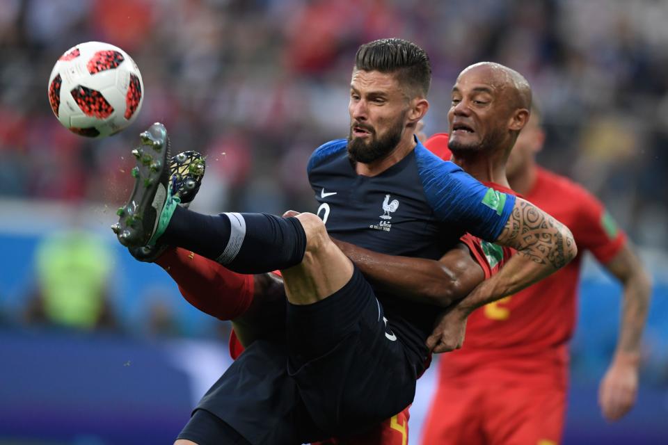 <p>France’s forward Olivier Giroud (L) vies for the ball with Belgium’s defender Vincent Kompany during the Russia 2018 World Cup semi-final football match between France and Belgium at the Saint Petersburg Stadium in Saint Petersburg on July 10, 2018. (Photo by GABRIEL BOUYS / AFP) </p>