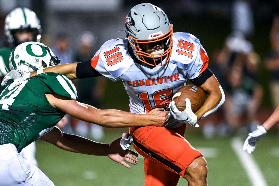 Charlotte's Ben Buzzard runs for a gain against Olivet during the third quarter on Friday, Aug. 26, 2022, at Olivet High School.