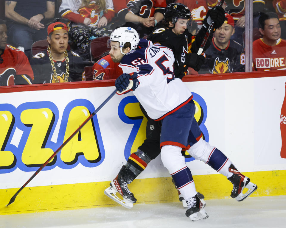 Columbus Blue Jackets forward Emil Bemstrom, left, checks Calgary Flames forward Jakob Pelletier during first-period NHL hockey game action in Calgary, Alberta, Monday, Jan. 23, 2023. (Jeff McIntosh/The Canadian Press via AP)