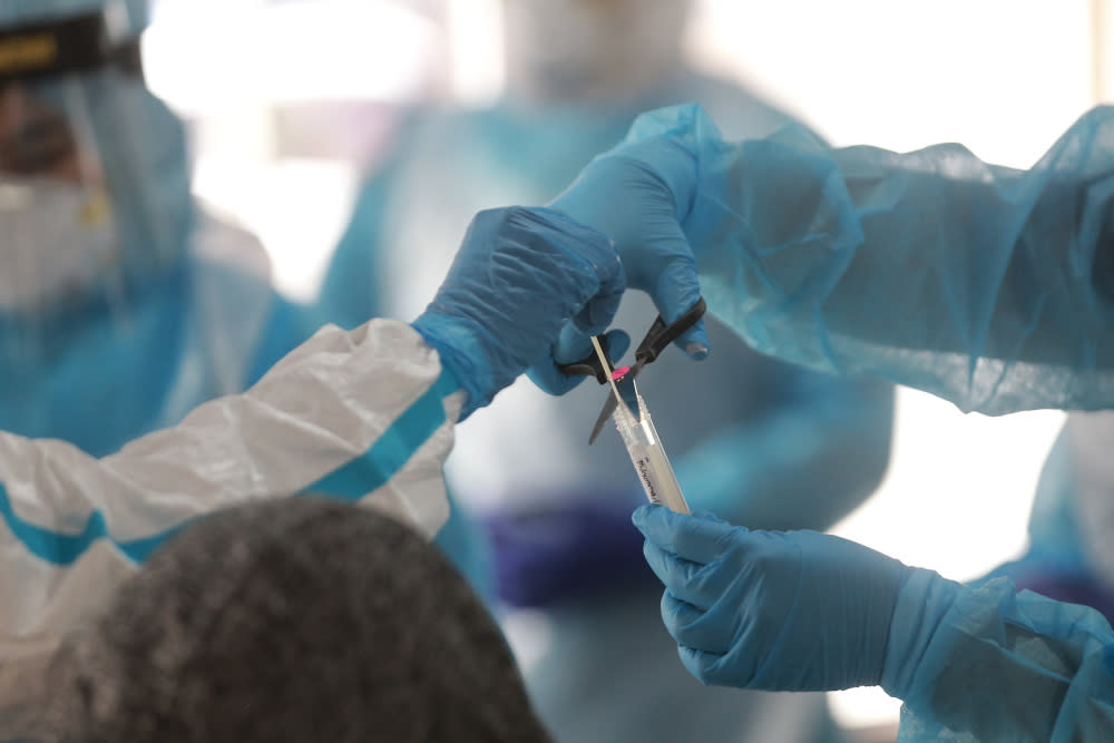 The Petaling District Health Clinic staff conducting Covid-19 swab tests at Pelangi Apartments October 21, 2020. — Picture by Ahmad Zamzahuri