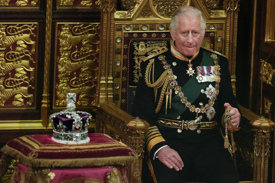 FILE - Prince Charles is seated next to the Queen's crown during the State Opening of Parliament, at the Palace of Westminster in London, May 10, 2022. Queen Elizabeth II did not attend the opening of Parliament amid ongoing mobility issues. Prince Charles has been preparing for the crown his entire life. Now, that moment has finally arrived. Charles, the oldest person to ever assume the British throne, became king on Thursday Sept. 8, 2022, following the death of his mother, Queen Elizabeth II. (AP Photo/Alastair Grant, Pool, File)