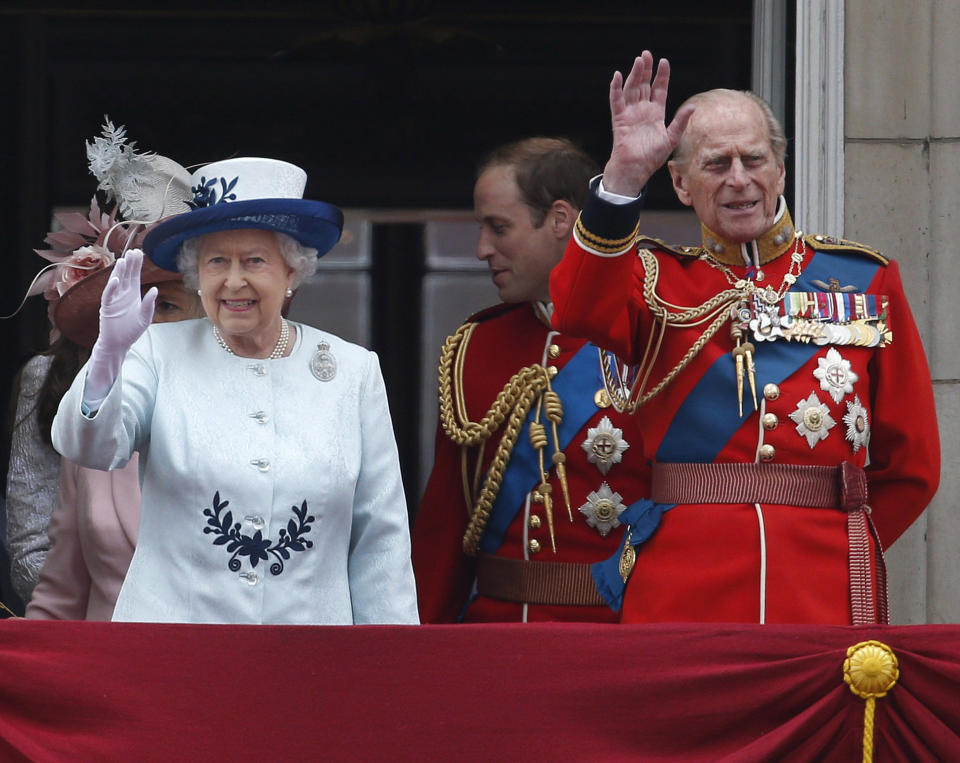 FILE - In this Saturday, June 14, 2014 file photo, Britain's Queen Elizabeth II, accompanied by Prince Philip, wave to the crowds from the balcony of Buckingham Palace, during the Trooping The Colour parade, in central London. Prince Philip was the longest serving royal consort in British history. In Britain, the husband or wife of the monarch is known as consort, a position that carries immense prestige but has no constitutional role. (AP Photo/Lefteris Pitarakis, File)