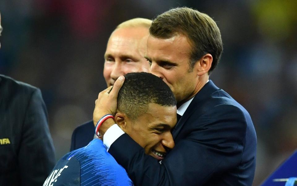 French president Emmanuel Macron embraces Mbappé after France's 2018 World Cup win - REUTERS