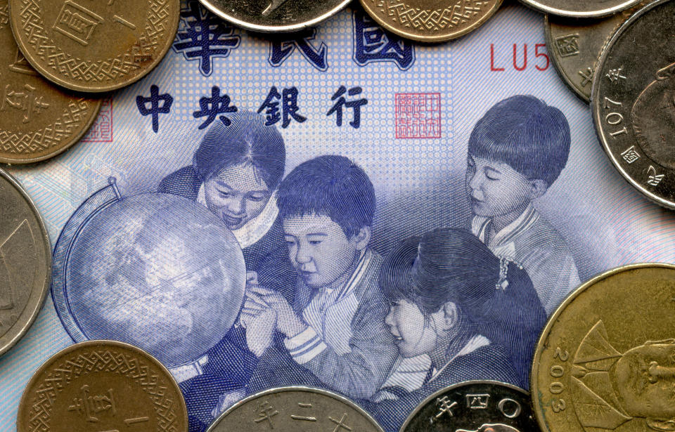 Close-up of various Taiwanese banknotes and coins