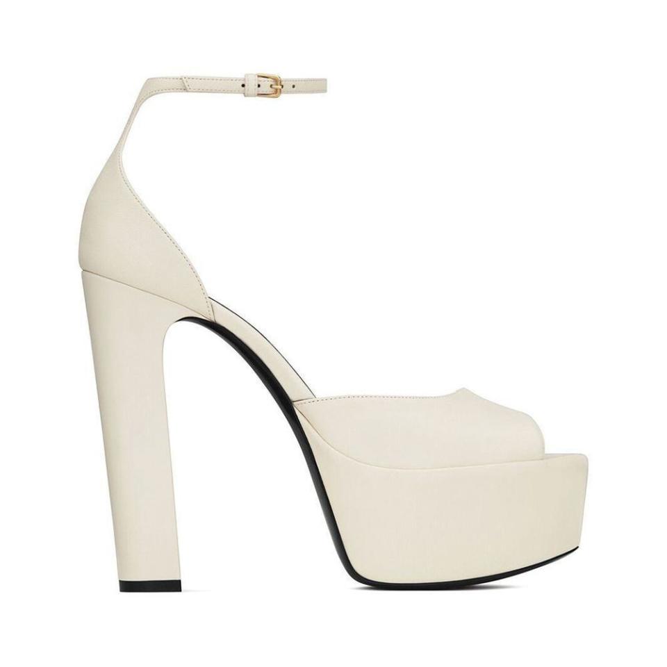 <p><a href="https://go.redirectingat.com?id=74968X1596630&url=https%3A%2F%2Fwww.mytheresa.com%2Fus%2Fen%2Fwomen%2Fsaint-laurent-jodie-platform-leather-sandals-white-p00698917&sref=https%3A%2F%2F" rel="nofollow noopener" target="_blank" data-ylk="slk:Shop Now;elm:context_link;itc:0;sec:content-canvas" class="link ">Shop Now</a></p><p>Jodie 145 platform leather sandals</p><p>mytheresa.com</p><span class="copyright">Saint Laurent</span>