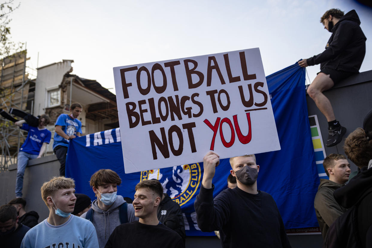 Chelsea fans celebrate outside the team's Stamford Bridge stadium.