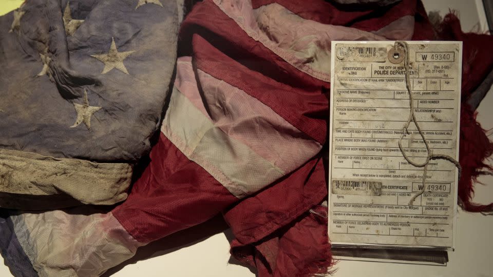 An NYPD death certificate and an American flag recovered at Ground Zero are displayed at the 9/11 Tribute Museum. - Drew Angerer/Getty Images North America/Getty Images