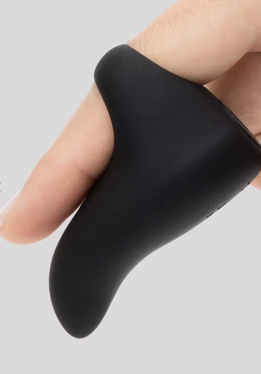 A model's hand showing a black Fifty Shades of Grey Rechargeable Finger Vibrator on one finger.