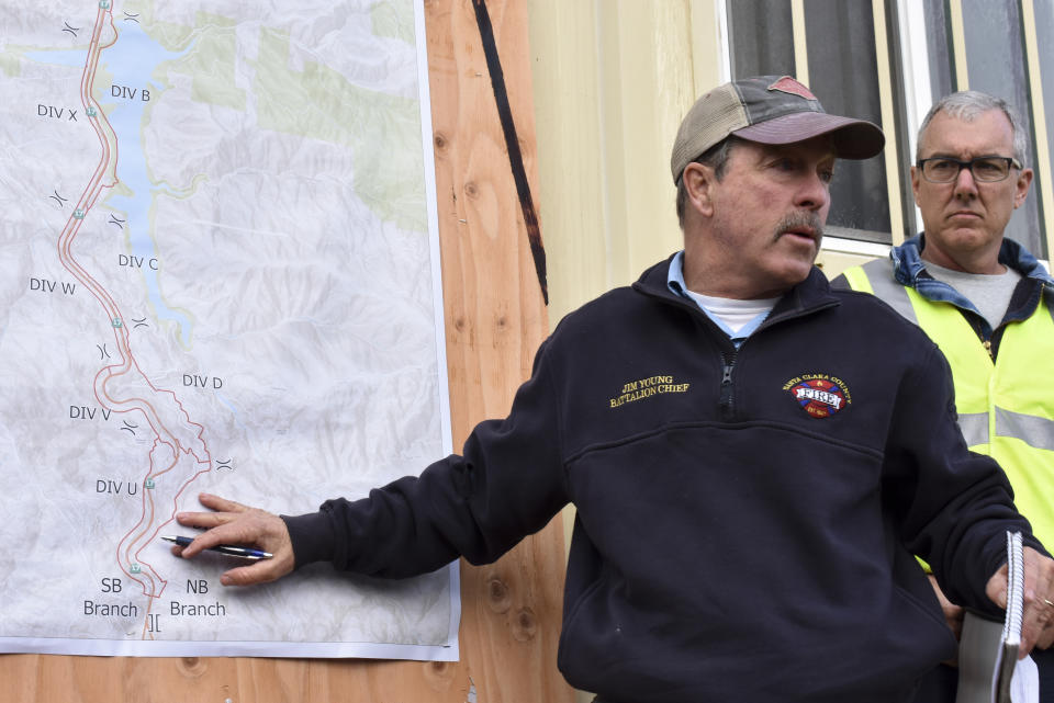 Jim Young with the Santa Clara County FireSafe Council gives a daily briefing to tree clearing crews working to reduce wildfire dangers along a crowded highway corridor in California’s Santa Cruz mountains on Wednesday, Nov. 20, 2019, near Los Gatos, California. State and local authorities are rushing to curb the consequences of increasingly destructive blazes that threaten year-round in portions of the Western U.S. (AP Photo/Matthew Brown)