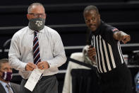 Texas A&M head coach Buzz Williams, left, talks to a game official during the first half of an NCAA college basketball game against New Orleans on Sunday, Nov. 29, 2020, in College Station, Texas. (AP Photo/Sam Craft)