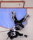 Los Angeles Kings goalie Jonathan Quick, top, is scored on by San Jose Sharks left wing Matt Nieto as defenseman Robyn Regehr, of Brazil, looks on during the second period in Game 3 of an NHL hockey first-round playoff series , Tuesday, April 22, 2014, in Los Angeles. (AP Photo/Mark J. Terrill)