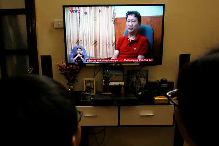 An image of Vietnamese former oil executive Trinh Xuan Thanh is seen on a TV screen on state-run television VTV, saying he turns himself in at a police station in Hanoi, Vietnam August 3, 2017. REUTERS/Kham/Files