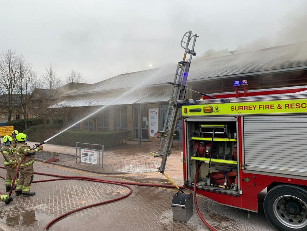 Handout photo dated 13/02/21 issued by @AboutTD on Twitter showing Surrey Fire and Rescue Service officers and vehicles at Emberbrook Community Centre, in Raphael Drive, Thames Ditton, which was being used as a vaccination centre but had to be evacuated after a fire broke out in the building. Issue date: Saturday February 13, 2021.