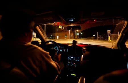 Taxi driver, Curtis Seymour of C&L Taxi, drives around town looking for fares in his cab in Plattsburgh, New York, U.S., April 25, 2017. REUTERS/Christinne Muschi