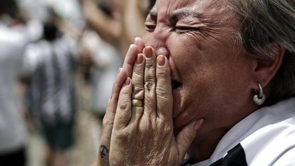 Fotografia colorida mostra close no rosto de uma mulher de pele clara chorando