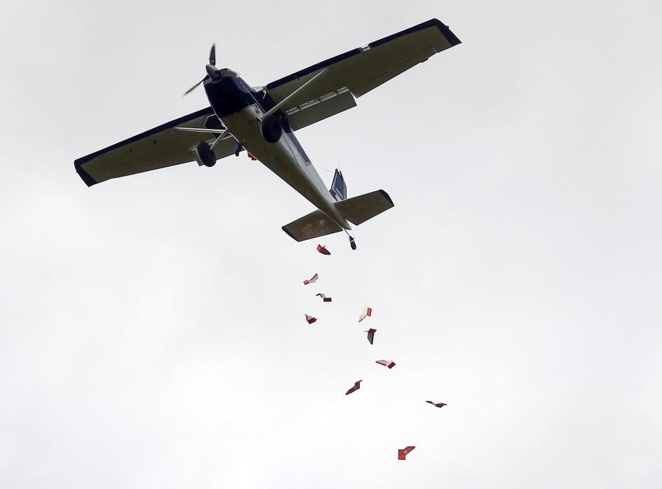 A plane drops a load of Five Forces AirWing packages onto the lawn at the Seabeck Conference Center on Oct. 20.