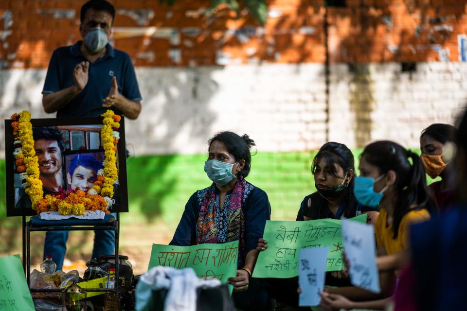 Participants display placards urging for justice for late Bollywood actor Sushant Singh Rajput, whose suicide sparked a media storm in India, during a demonstration in New Delhi on October 7, 2020. (Photo by Jewel SAMAD / AFP) (Photo by JEWEL SAMAD/AFP via Getty Images)