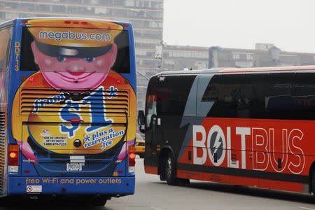 A Megabus and a Boltbus buses cross paths in New York City May 8, 2014. REUTERS/Eduardo Munoz