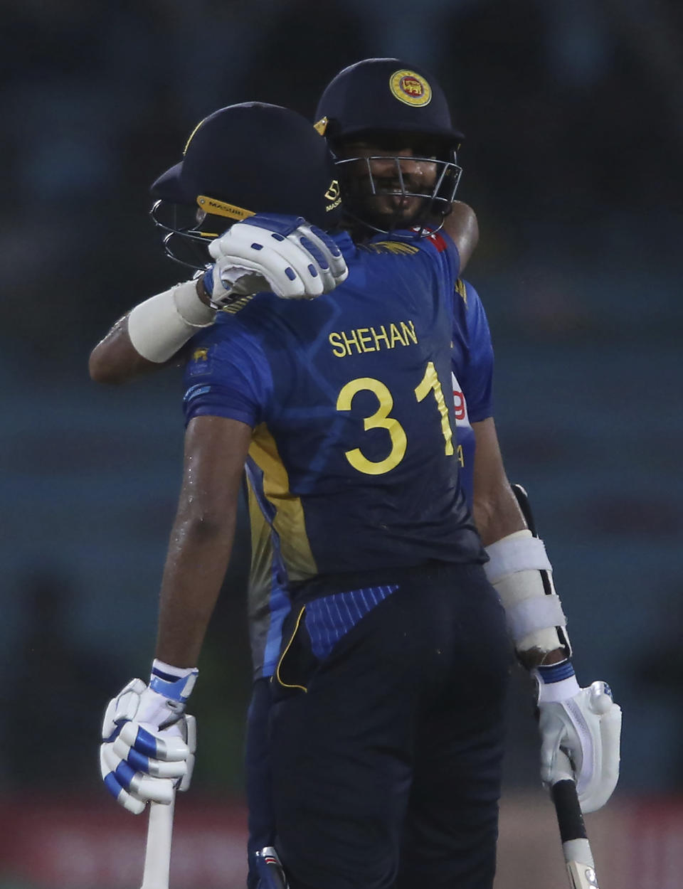 Sri Lankan batsman Dasun Shanaka, right, celebrates his fifty with Shehan Jayasuriya during the second one-day international in Karachi, Pakistan, Monday, Sept. 30, 2019. Pakistan marked return of ODI cricket in Karachi after 10 years with a 67-run victory over Sri Lanka in the second one-day international of the three-match series on Monday. (AP Photo/Fareed Khan)