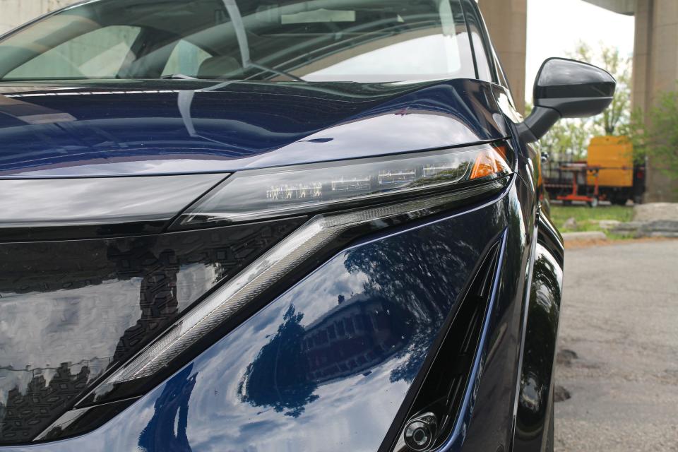 A close up shot of the Nissan Ariya electric SUV's headlight.