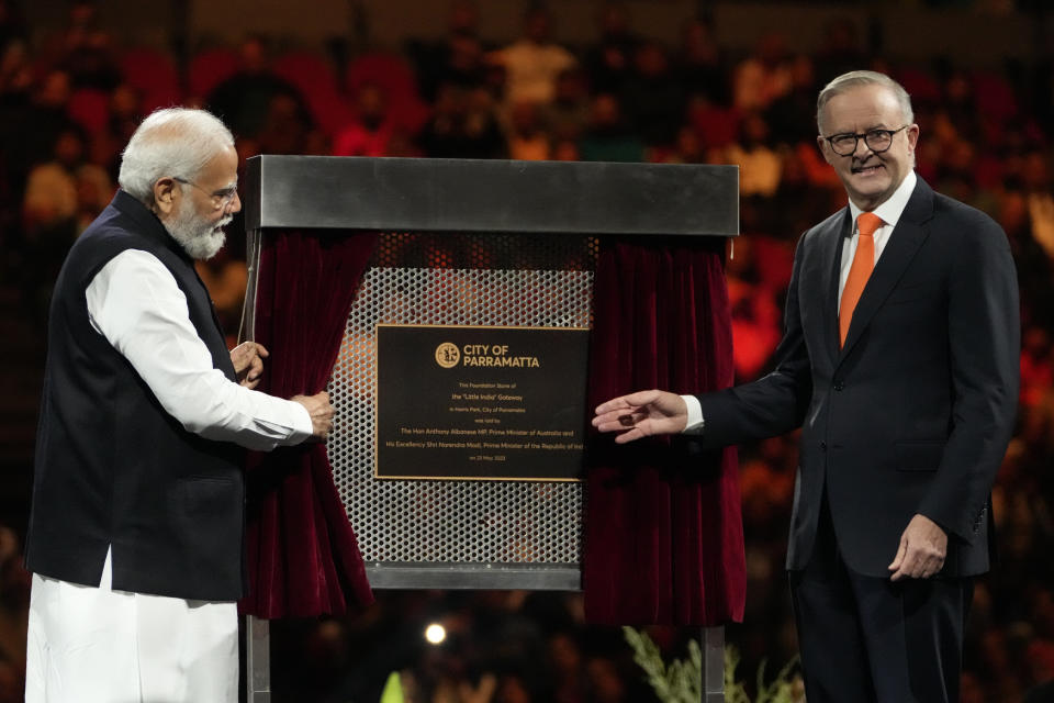 Indian Prime Minister Narendra Modi, left, and his Australian counterpart Anthony Albanese unveil a plaque of the foundation of the "Little India" gateway, during an Indian community event at Qudos Bank Arena in Sydney, Australia, Tuesday, May 23, 2023. Modi has arrived in Sydney for his second Australian visit as India's prime minister and told local media he wants closer bilateral defense and security ties as China's influence in the Indo-Pacific region grows. (AP Photo/Mark Baker)