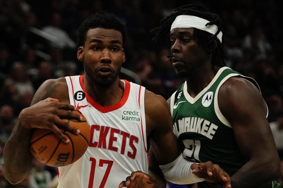 Houston Rockets' Tari Eason drives past Milwaukee Bucks' Jrue Holiday during the first half of an NBA basketball game Saturday, Oct. 22, 2022, in Milwaukee. (AP Photo/Morry Gash)