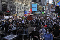 Protesters gather in Times Square before marching through the streets of Manhattan in New York, Monday, June 1, 2020. New York City imposed an 11 p.m. curfew Monday as the nation's biggest city tried to head off another night of destruction erupting amid protests over George Floyd's death. (AP Photo/Seth Wenig)