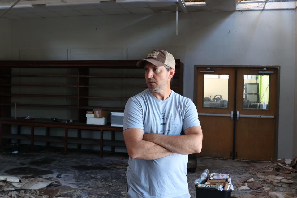 Gregg Pla looks around his store, Talquin Trading Co., in Railroad Square. The Tallahassee art district was badly damaged by a tornado and severe storms Friday morning.