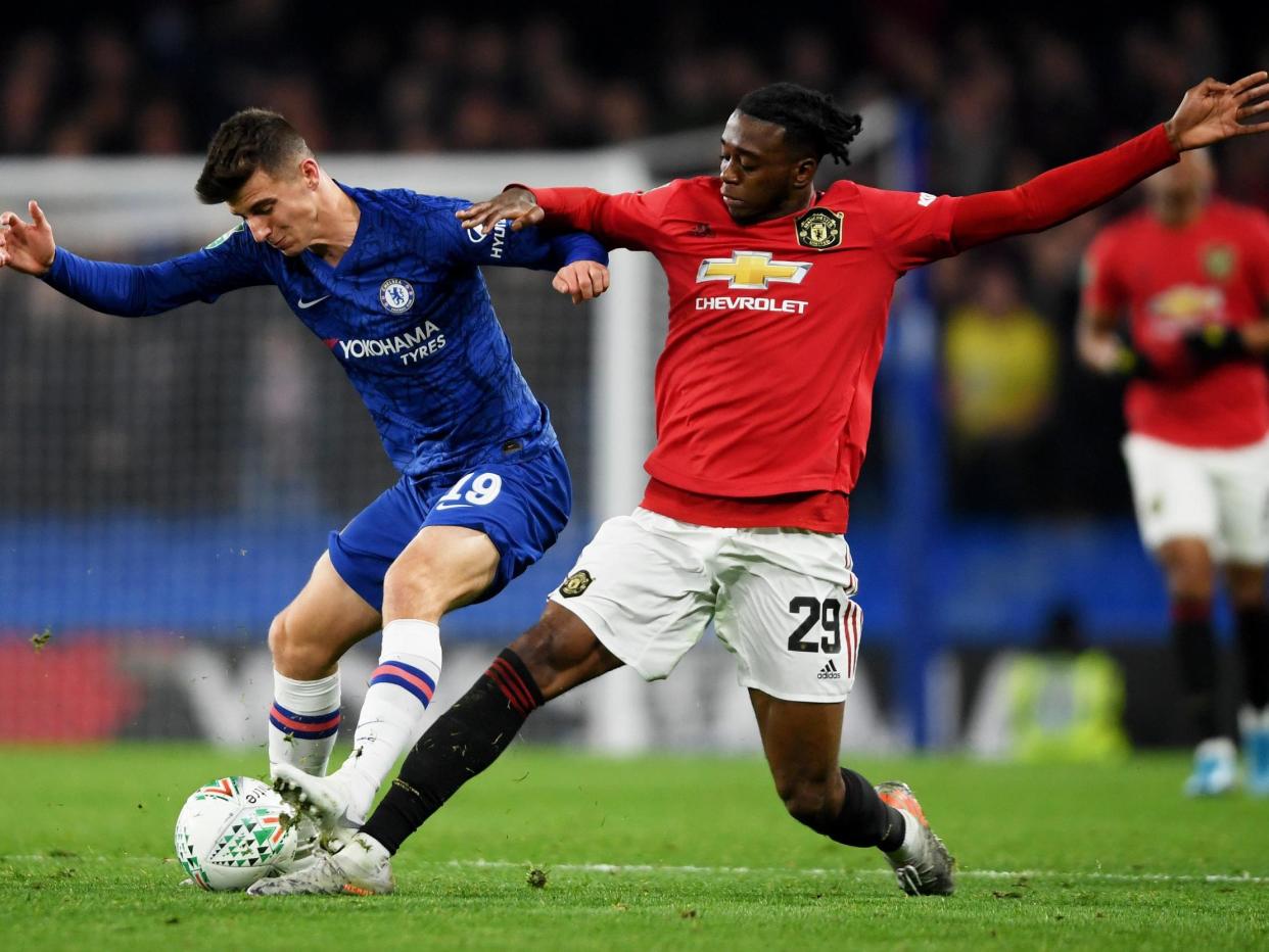 Mason Mount of Chelsea is challenged by Aaron Wan-Bissaka of Manchester United: Getty Images