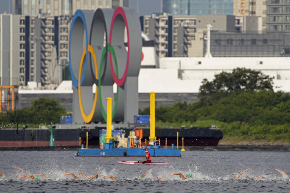 <p>Athletes compete in the swim leg of the men's individual triathlon at the 2020 Summer Olympics, Monday, July 26, 2021, in Tokyo, Japan. (AP Photo/Jae C. Hong)</p> 