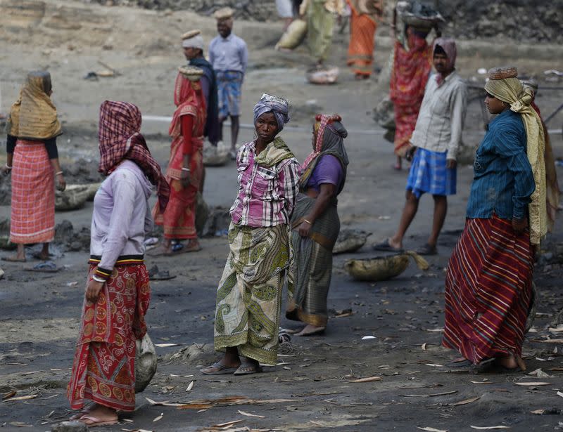 Village women work at a dry pond under the Mahatma Gandhi National Rural Employment Guarantee Act in Vastara
