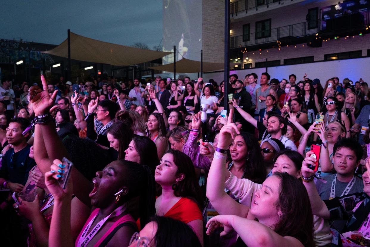 The crowd watches American singer, songwriter and producer Jvke performs at the Inn Cahoots Outdoors during the 2023 South by Southwest Music Festival. Wristbands that provide access to most music shows will be made available to Austinites in the weeks before the festival.