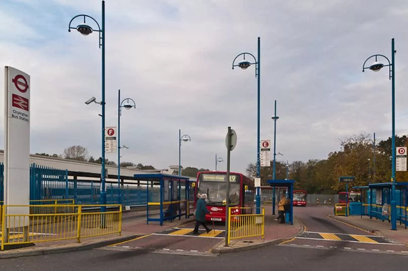 General view of Orpington bus station featuring bus at stop and elderly woman