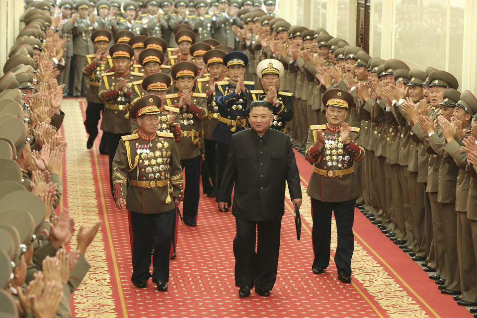 In this photo provided by the North Korean government, North Korean leader Kim Jong Un, center, is applauded by military commanders in Pyongyang, North Korea, on July 24, 2021. North Korea said Friday, July 30, 2021 that Kim called for stronger capability to cope with any foreign provocation as he met with military officers ahead of annual drills next month between South Korea and the United States that Pyongyang views as an invasion rehearsal. Independent journalists were not given access to cover the event depicted in this image distributed by the North Korean government. The content of this image is as provided and cannot be independently verified. (Korean Central News Agency/Korea News Service via AP)