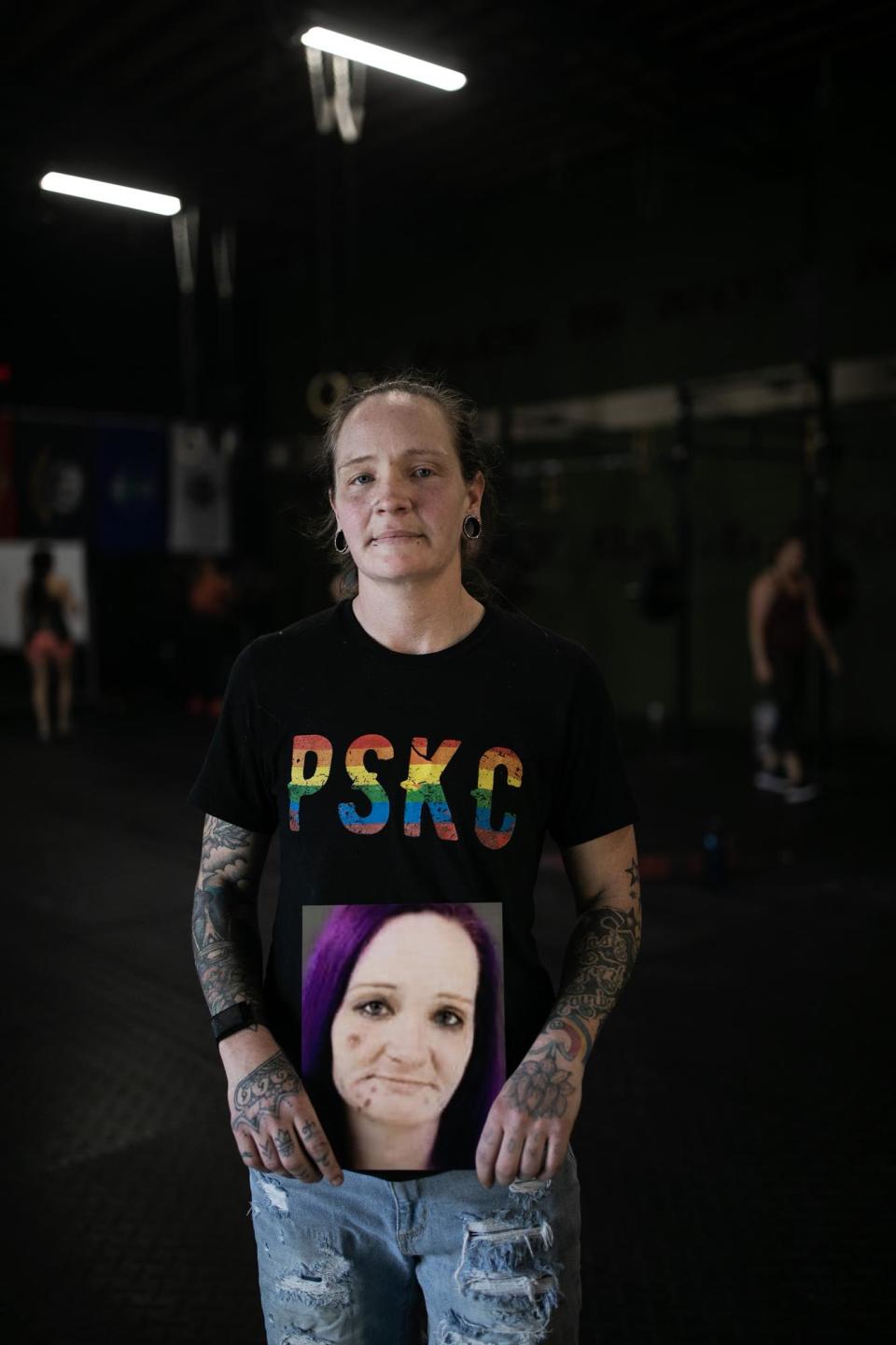Sarah Wilson holds her old mug shot at the PSKC CrossFit gym in Portsmouth, OH on May 8, 2023.